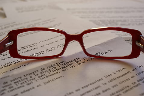 clear eyeglasses with red frames on top of book page, sunglasses HD wallpaper