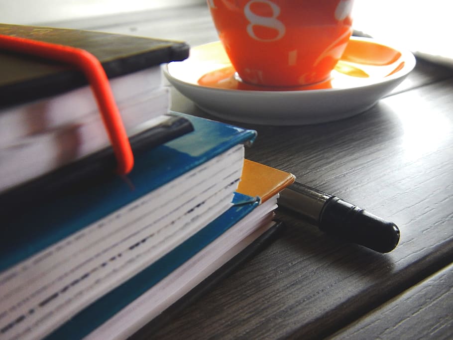 stack of assorted-title books beside pen, Office, Cup, Address Book HD wallpaper