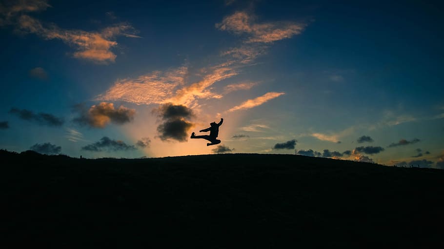 silhouette of person doing flying kick on hill, silhouette of person jumping in mid air HD wallpaper