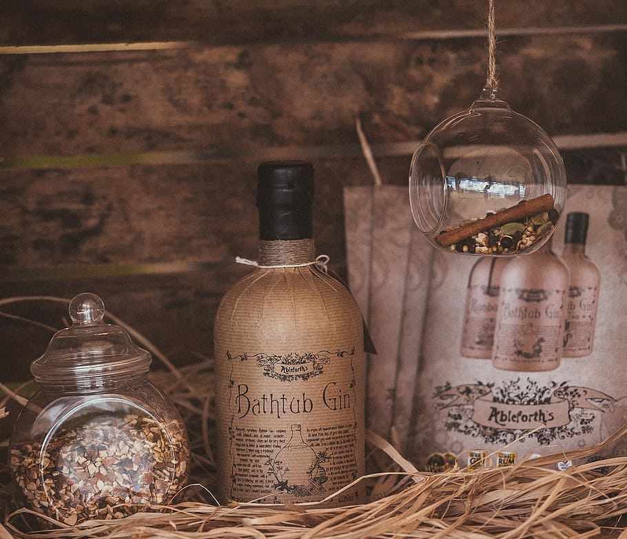 Bathtub Gin, Bathtub Gin bottle in between cards and clear glass jar on straw surface HD wallpaper