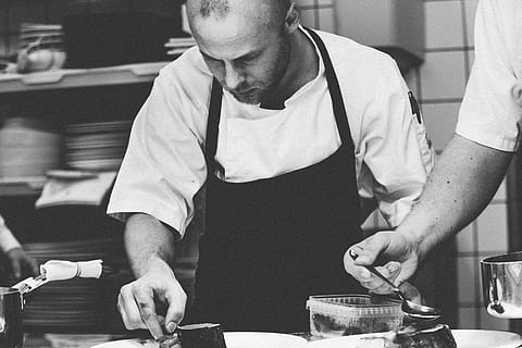 grayscale photography of chef preparing dish, man garnishing the dish HD wallpaper