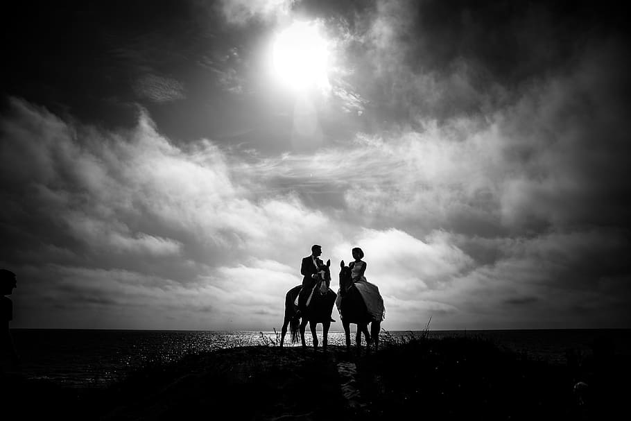 Grayscale Photography of Couple Riding on Horse With Body of Water and Sky As Background HD wallpaper