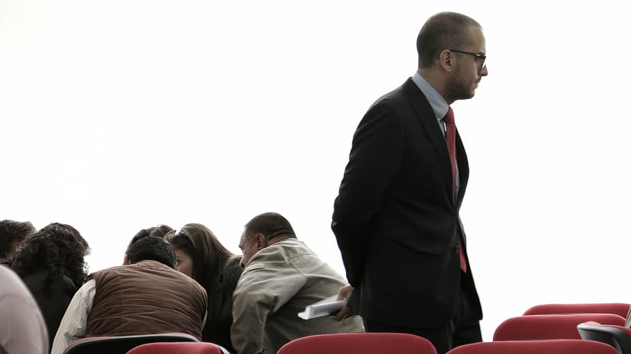 man standing surround by red chairs inside the room, conference HD wallpaper