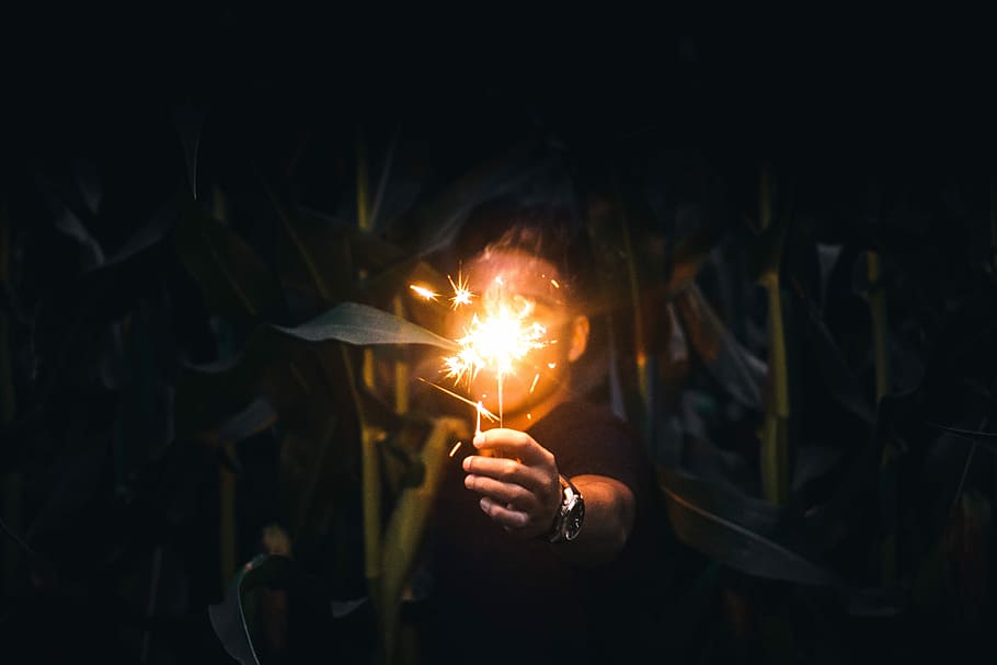 man holding sparkler at nighttime, man holding sparkling sparkler HD wallpaper