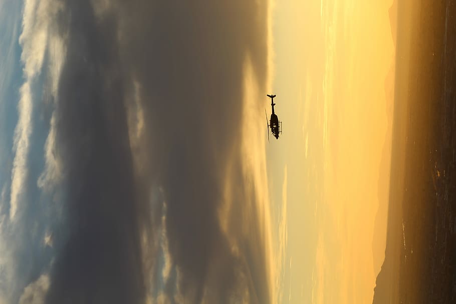 black helicopter on air, silhouette of helicopter on sky, yellow HD wallpaper
