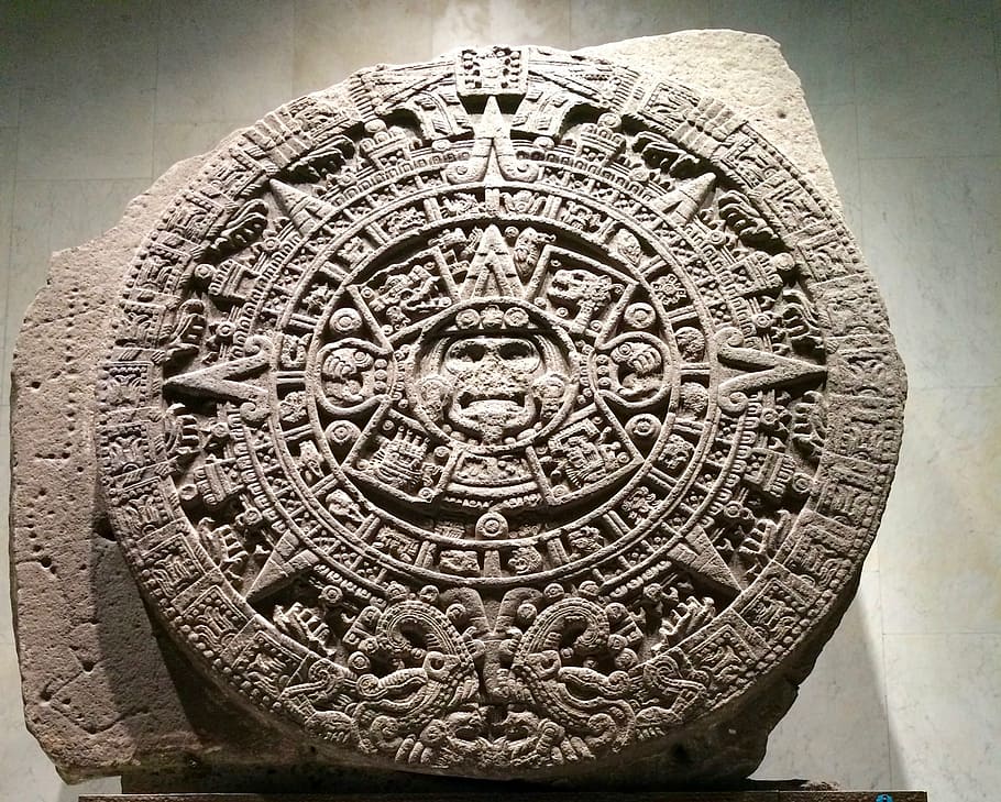 selective focus photography of stone Mayan calendar inside room