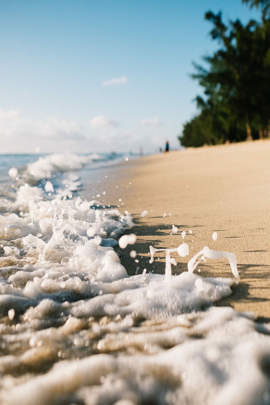 closeup photo of ocean, beach side, waves, sea, sand, foam, splash