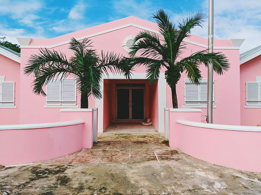 pink and white concrete house near green trees under cloudy sky, pink storey house with palm trees HD wallpaper
