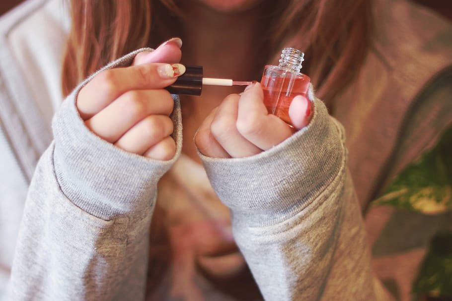 woman holding nail polish, women, people, one Person, human Hand HD wallpaper