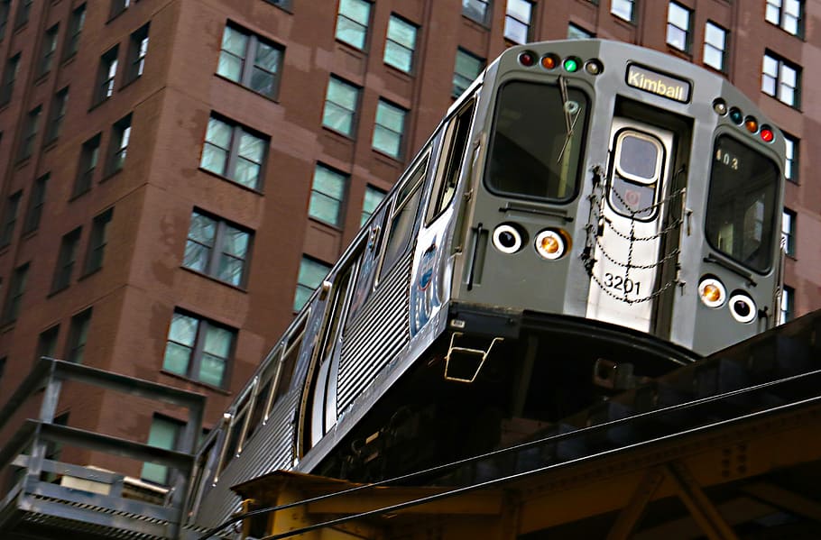 gray train near building, low-angle photography of train near buildings at daytime HD wallpaper