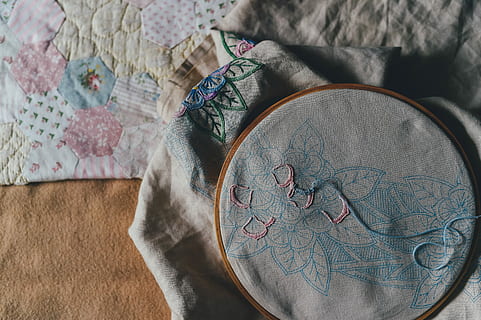 embroidery near textile, photo of gray and blue flower cross-stitch artwork HD wallpaper