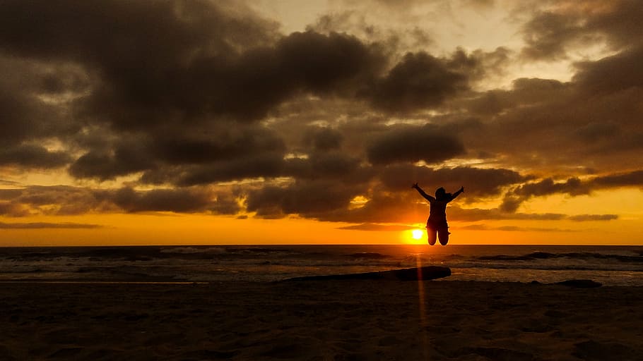 person jumping on seashore during sunset, sunrise, campeche, beach