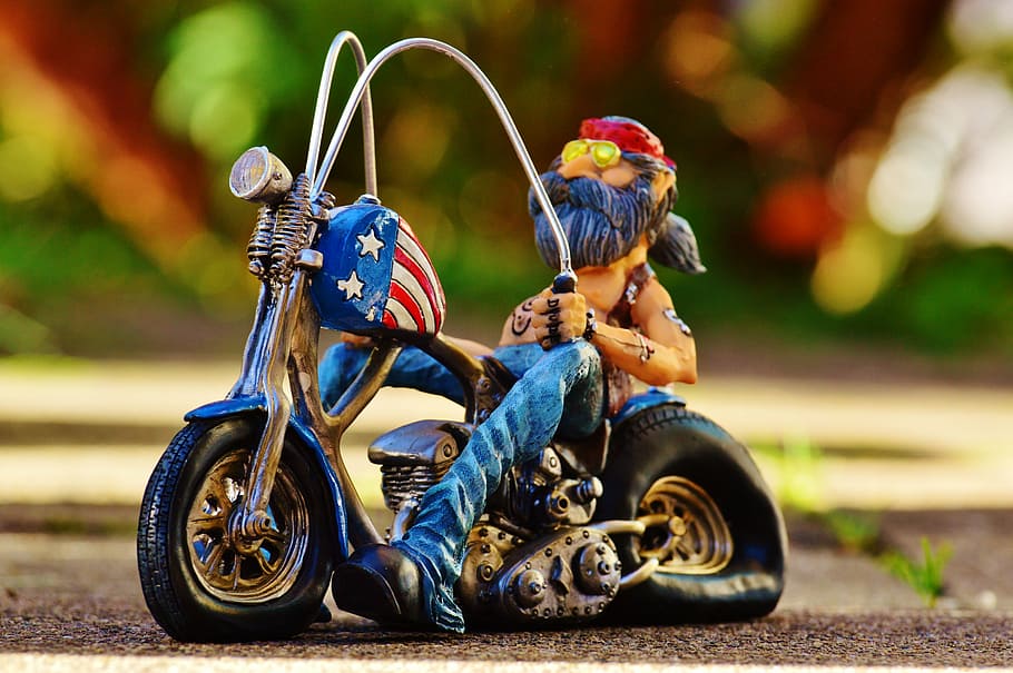 shallow focus photography of man on motorcycle figurine, biker