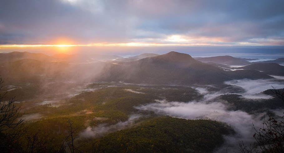 mountains with fog during daytime, aerial photography of mountains under white clouds during daytime HD wallpaper