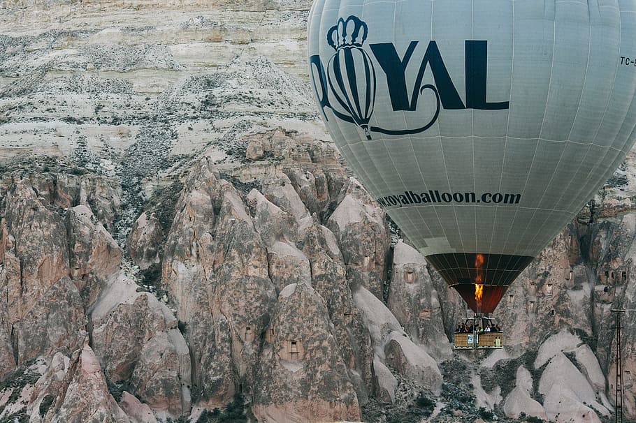white and black Royal hot air balloon near mountain, gray and black Royal hot air balloon HD wallpaper