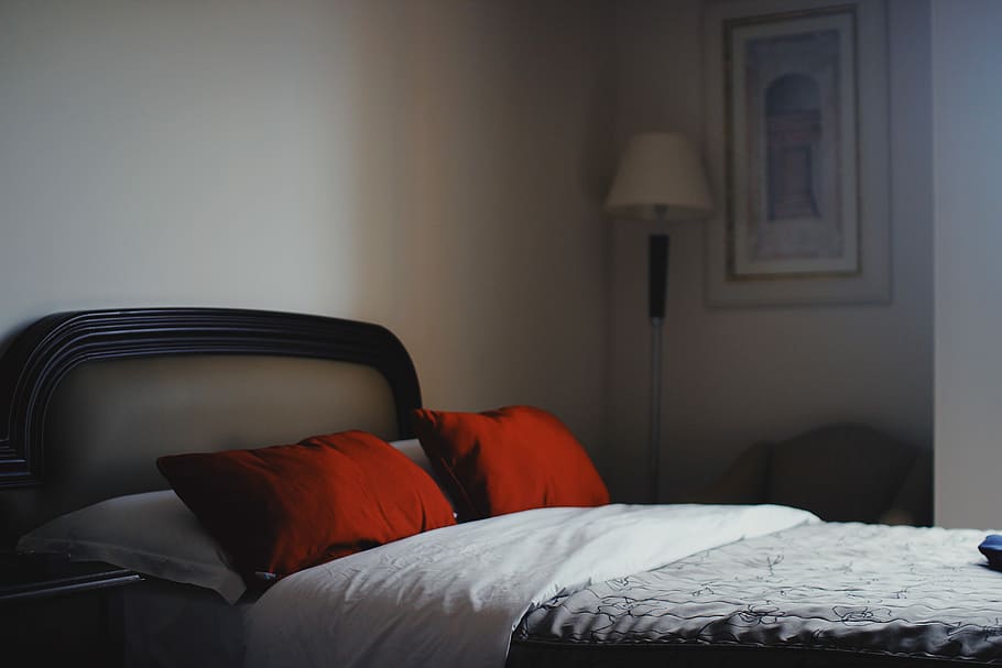 two red pillows and gray and white floral bedspread, bed inside white painted bedroom HD wallpaper