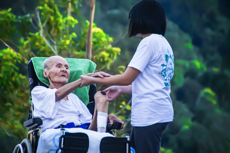 girl holding his grandmother hand, hospice, caring for elder