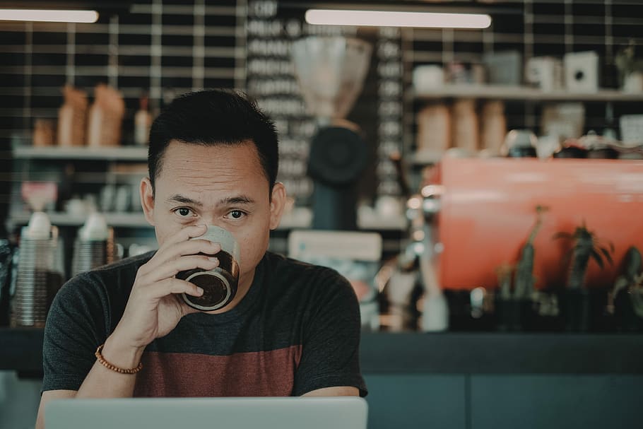 man drinking on mug while sitting, man sipping coffee in front of laptop, HD wallpaper