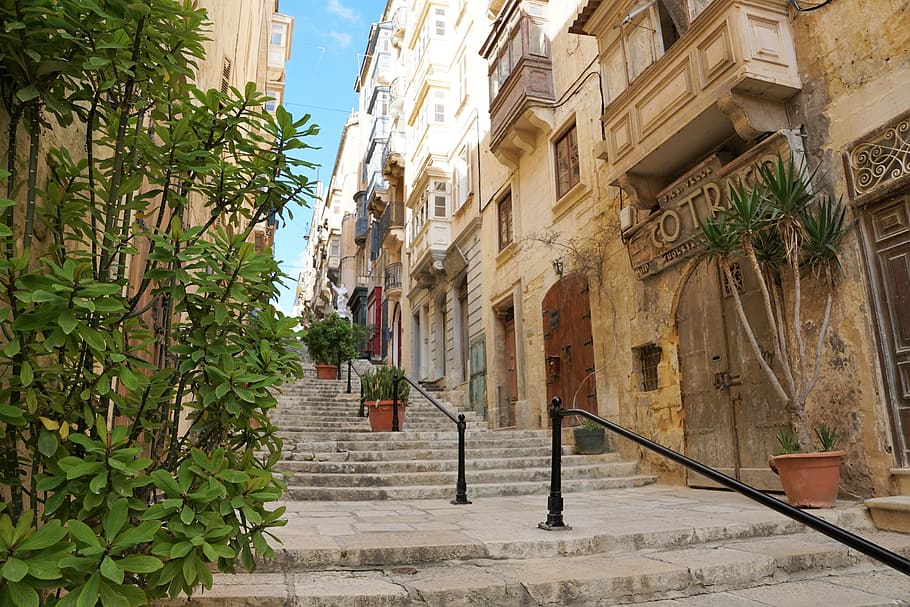 gray concrete stairs with black handrail during daytime, valetta