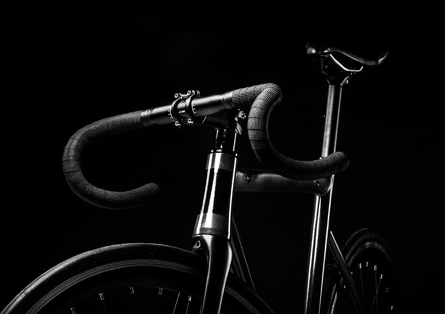 grayscale photography of road bicycle, grey scale photography of road bicycle with black background