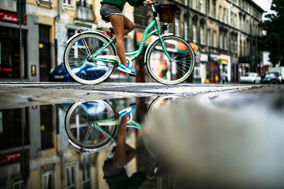 person riding on teal dutch bicycle, person riding on teal step-through bike beside cconcrete building, HD wallpaper
