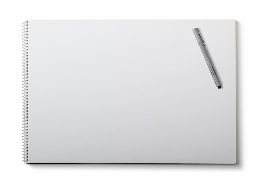 white sketch pad and silver pen on top, drawing pad, white background