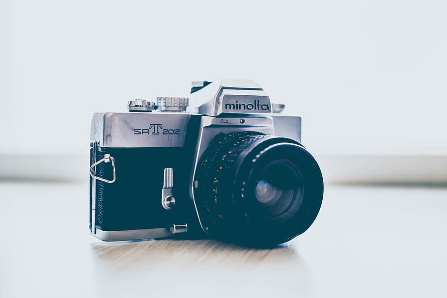 gray and black Minolta DSLR camera, shallow focus photography of black and silver Minolta SLR camera HD wallpaper