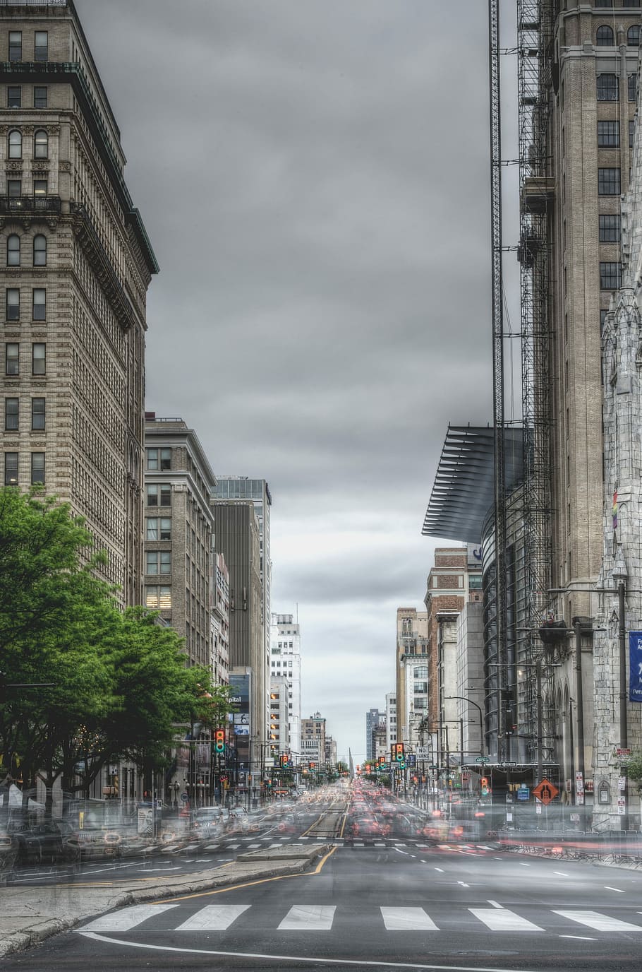 Time Lapse photo of running vehicles on road surrounded by concrete high rise buildings under gray sky during daytime HD wallpaper