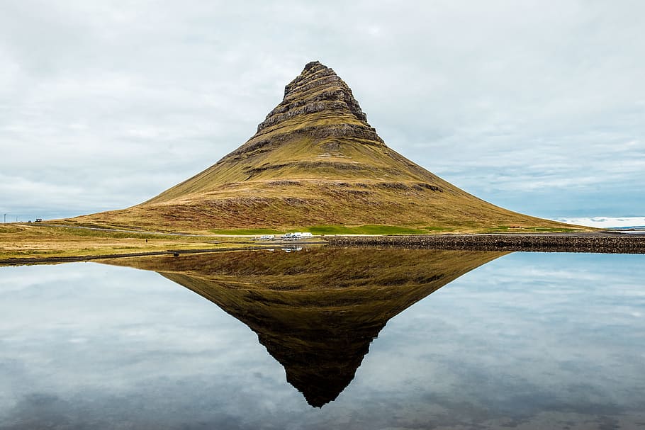 brown mountains surrounded by body of water during daytime photography, green mountain with reflection on water HD wallpaper