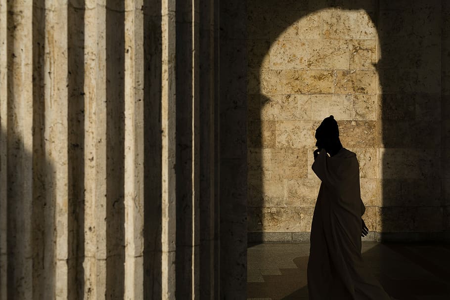 silhouette of a man standing near large column, person standing inside Parthenon during daytime HD wallpaper