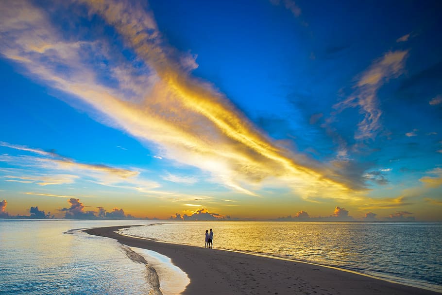 two person standing on beach shore with a pathway leading on ocean HD wallpaper
