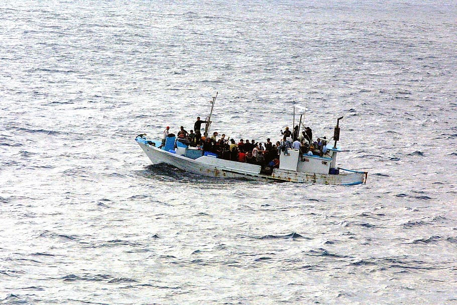 photo of people on white ship, boot, water, refugee, escape, asylum