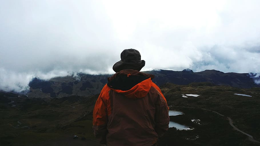 person standing and looking the mountain, man standing on the hill looking at the mountain HD wallpaper