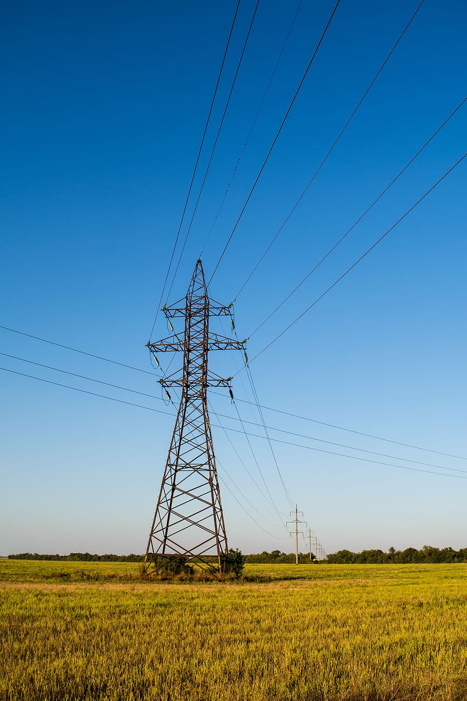 landscape photography of transmission tower, brown electric tower on grass field HD wallpaper