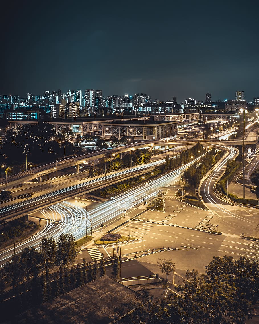 aerial timelapse photography of cars passing on road intersection at night time, aerial photograph of a city