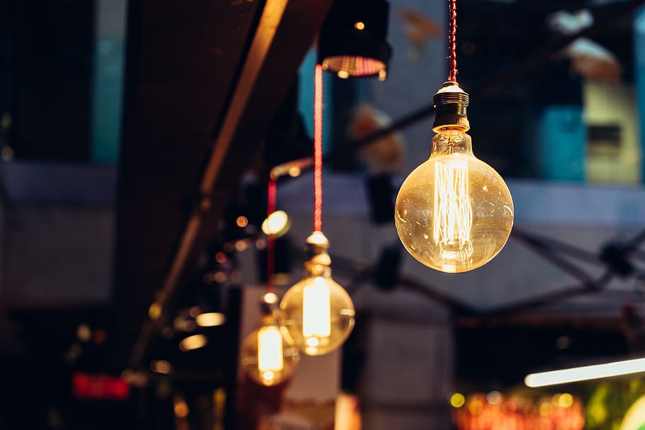 selective focus of lighted light bulbs, selective focus photography of orange hanging lights