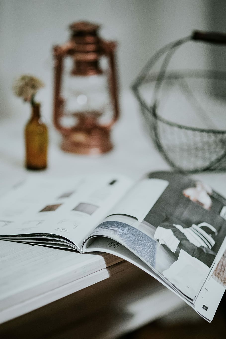 Magazine with a paraffin lamp on a white table, bottle, journal HD wallpaper