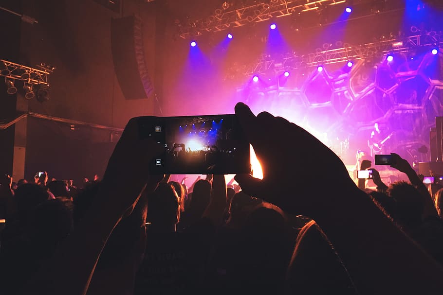 A person photographer in the crowd taking a photo with their mobile phone at a music concert festival, HD wallpaper