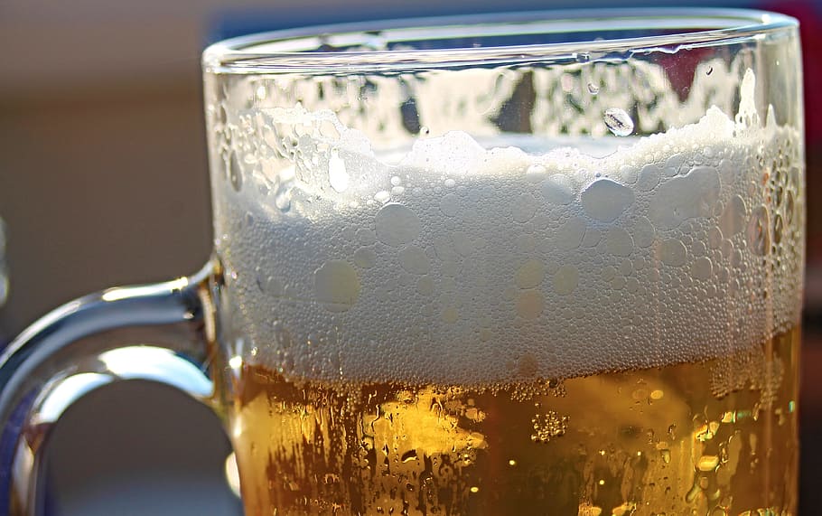 clear glass beer mug filled with beer close-up photo, beer tankard