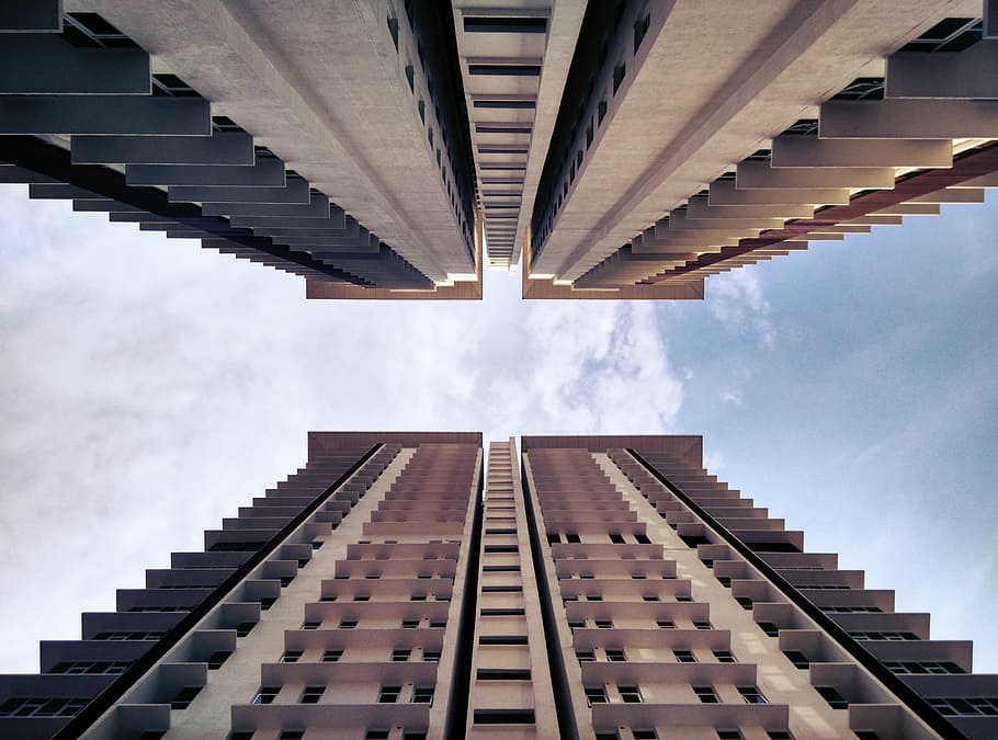 low-angle photography of two buildings, high angle photography of two beige-and-gray high rise buildings HD wallpaper