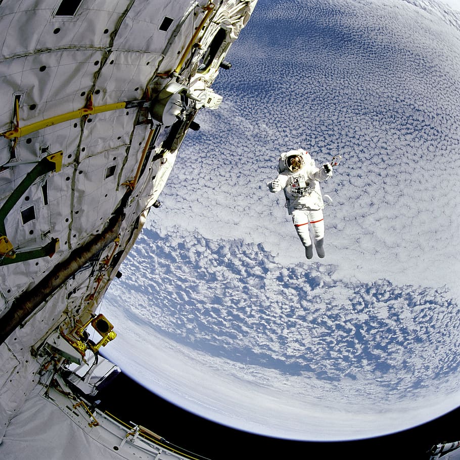 astronaut floating above planet, space, sky, suit, nasa, clouds HD wallpaper