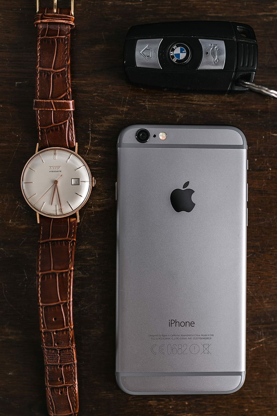 Apple iPhone 6 and Vintage watch on a brown leather wallet, technology