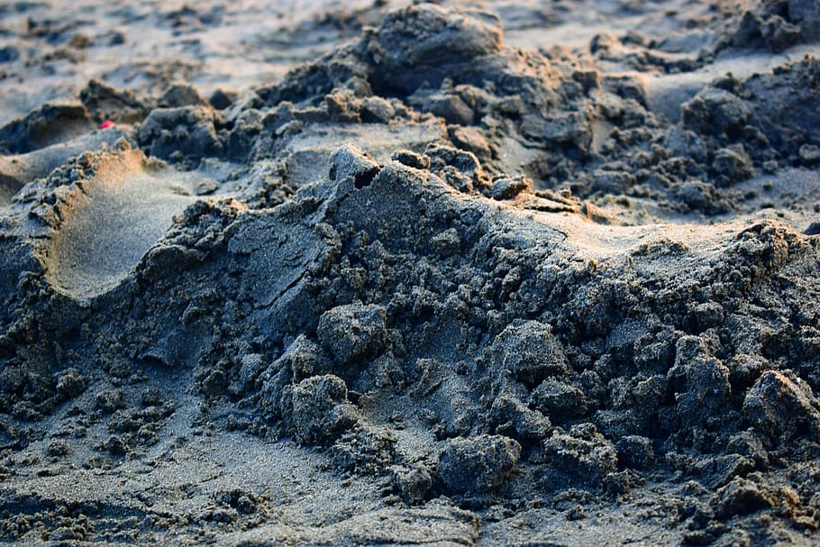 Beach sand, pile of gray sand, sunlight, rock, land, no people HD wallpaper