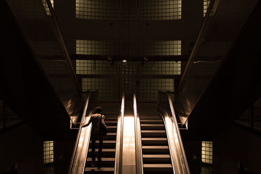 woman standing on escalator, person going up the escalator, Paris HD wallpaper