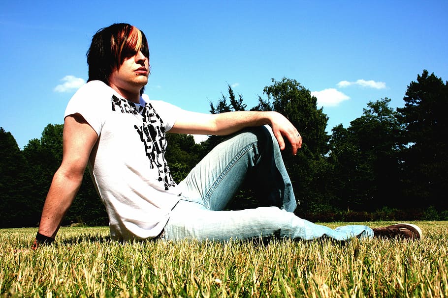 man sitting on grass surrounded by trees, male, punk, emo, meadow HD wallpaper