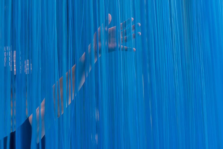 person touching blue curtain, person touching blue string curtain HD wallpaper