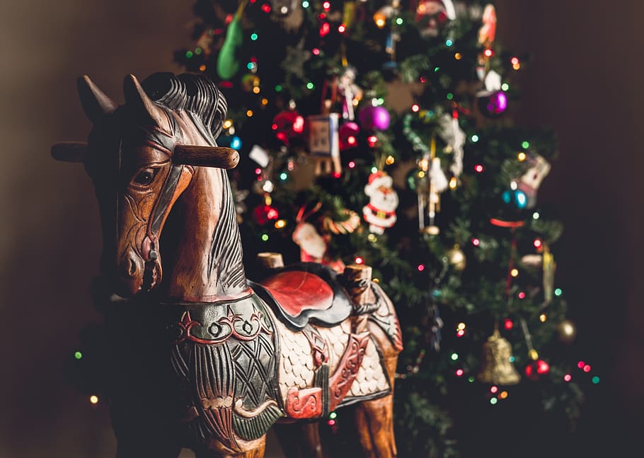 shallow focus photography of wooden ride-on horse beside Christmas tree HD wallpaper