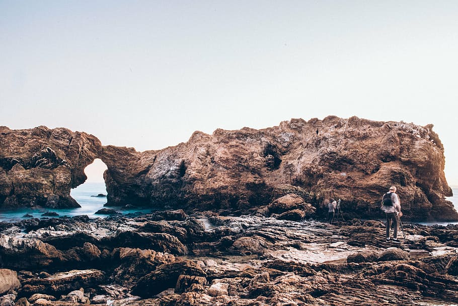 person standing near rock formation during daytime, man, body HD wallpaper
