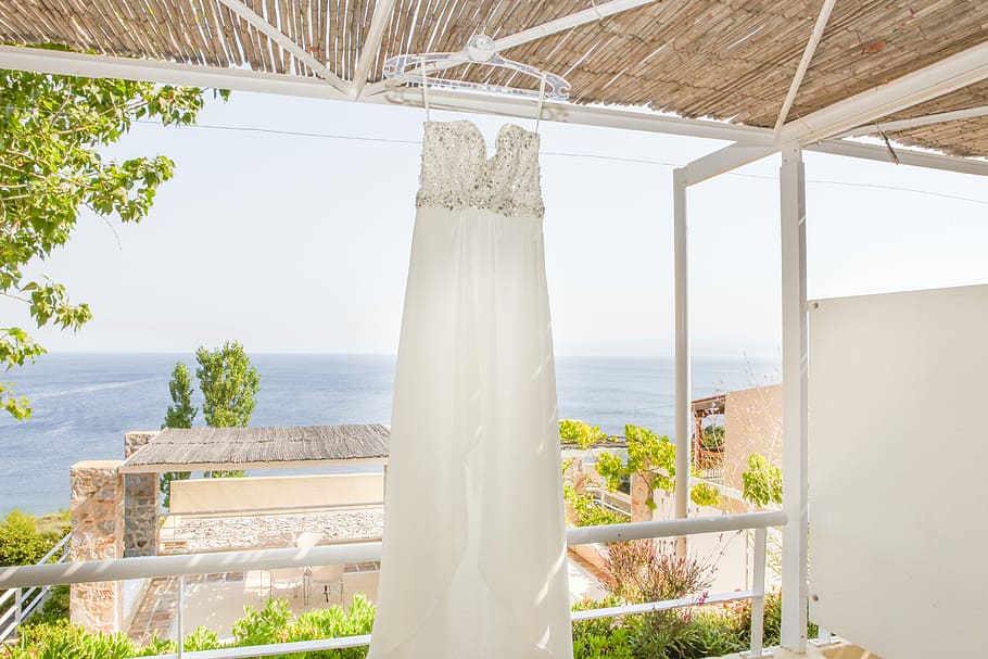 Skiathos Wedding Dress, women's white strapless wedding dress hanged on white clothes hanger