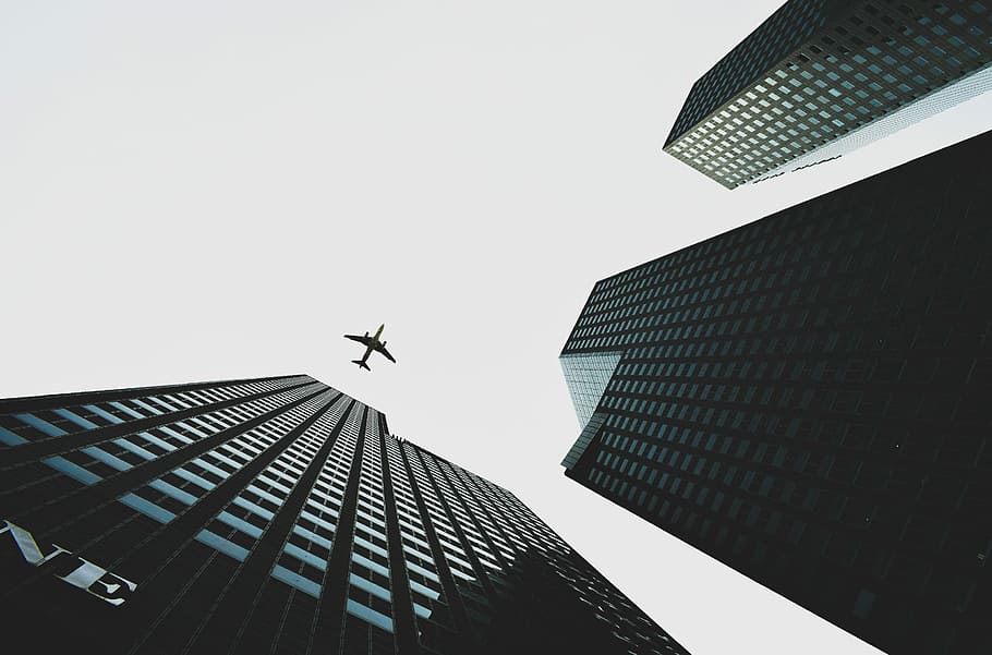 worm's eye view of building, low angle photography of airplane silhouette HD wallpaper